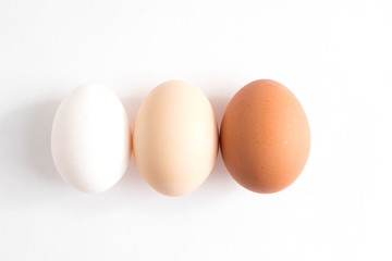 Three eggs on white background. Top view