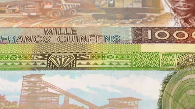 Guinea franc banknotes fast tracking. Guinean money. Slider shot, low angle. 4K