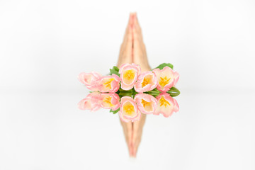 Hands and tulip flowers in vase isolated on white