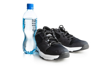 Black sports shoes and bottle of water