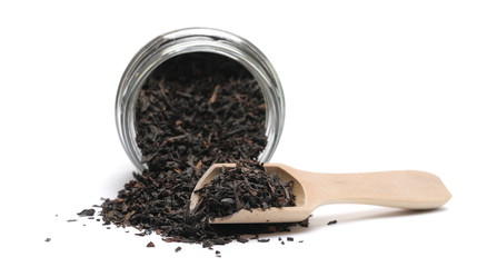 Black tea in glass jar isolated on white