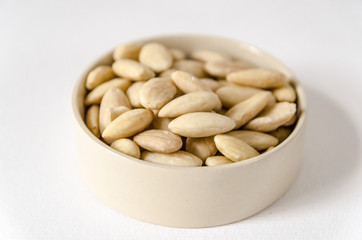 A tiny bowl full of almonds