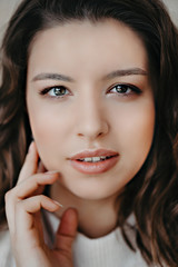 Beautiful young brunette girl close portrait looking in camera