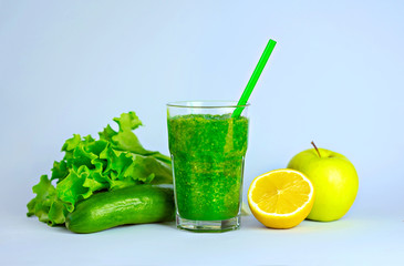 Green detox smoothie with vegetables on blue background. Healthy drink. ..