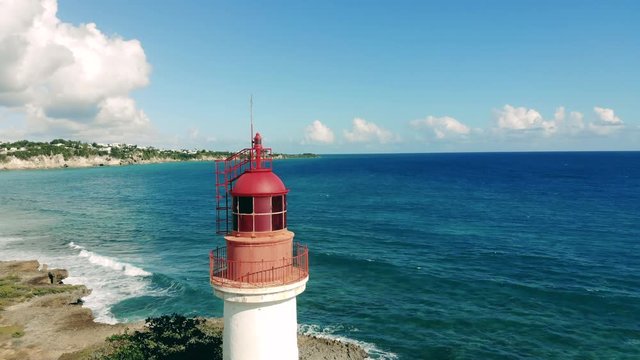 Half-round view of a lighthouse located at the seashore