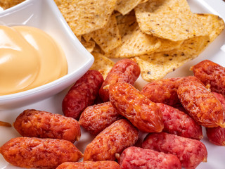 appetizer for beer from sausages and cheese sauce