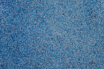 Texture of small stones of blue , blue and white color . Background with mixed colored gravel