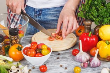 Woman cooks at the kitchen, body part