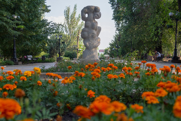 Stone statues and flowers on Pushkin Boulevard. Donetsk, Ukraine