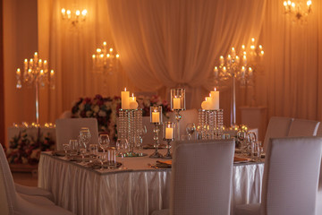 festive table decorated with flowers , cloth and candlestick. luxury wedding decoration with light. selective focus