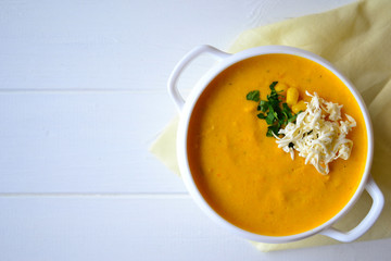 Corn soup with parsley and bread on a white background