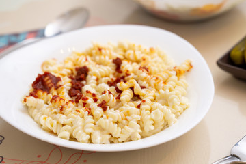 pasta with yogurt and tomato sauce in a white plate, turkish meal
