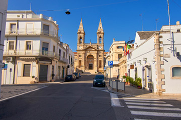 Fototapeta na wymiar Basilica of Saint Cosmas and Damian And Surrounding Streets At Alberobello Apulia Italy