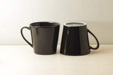 black porcelain cup on a bright wooden table