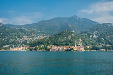 Fototapeta na wymiar Varenna, Italy sits beside Lake Como beneath forested mountains
