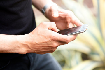 young man holding phone in hand