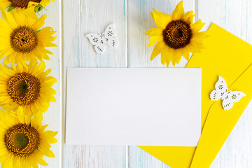 Mock up template with sunflower flowers and an envelope for writing. Frame for text with flowers for greeting card and email newsletter.