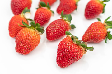 Fresh delicious strawberries isolated above white background.