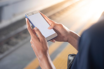 close up of the hands of a man who is using his smart phone