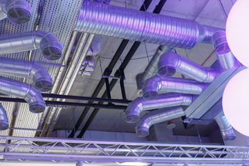 Industrial ventilation system ducts and pipes and electrical communications under ceiling