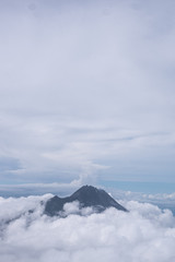 Mountain surrounded by thick clouds