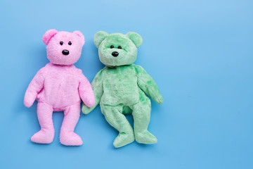 Bear toy couple on blue background.