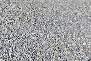 background of pebbles on the beach of the sea coast
