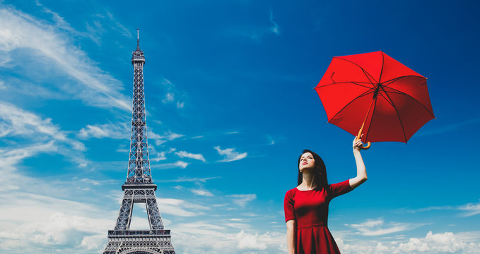 girl with umbrella on background with Eiffel tower