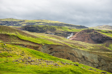 Obraz premium Wonderful icelandic nature landscape. View from the top. High mountains, mountain river and green grassland. Green meadows. Iceland.