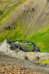 Wonderful icelandic nature landscape. View from the top. High mountains, mountain river and green grassland. Green meadows. Iceland.
