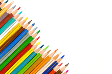 Crayons - colored pencil set arranged on white background