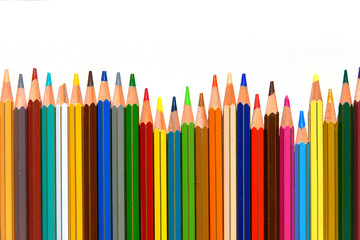 Crayons - colored pencil set arranged on white background