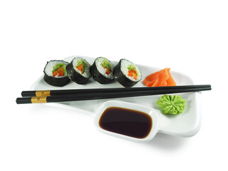 Vegetable sushi roll with paprika, salad and avocado on plate with wasabi, ginger, soy sauce and  black-golden chopsticks isolated on white background. Vegetarian food.