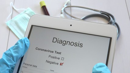 Medical doctor reading COVID-19 disease negative test results on tablet, physician with blue gloves receiving Sars-CoV-2 check up results, nurse hands getting Coronavirus 2019-nCoV diagnosis on pad - Powered by Adobe
