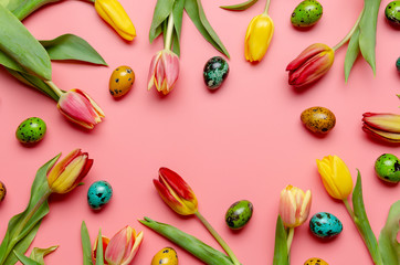 Set of same size tinted quail easter eggs with spring flowers.