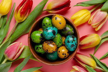 Set of same size tinted quail easter eggs with spring flowers.