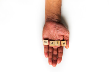 An isolated hand displays the message "WASH". Handwashing concept.