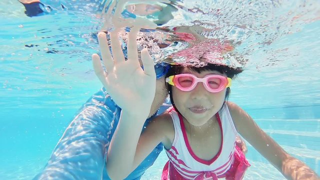 asian family in swimming pool