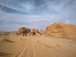 Fototapeta na wymiar car tracks and desert landscape of Wadi Rum desert in southern Jordan. 