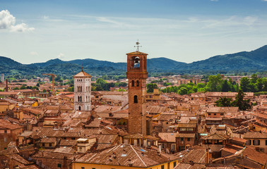 Fototapeta na wymiar View of Lucca old historic center with medieval towers and belfries from above