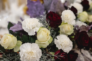 Beautiful and stylish bouquet fresh white and red roses. Summer floral composition on holiday table. Elegant arrangement floristics setting