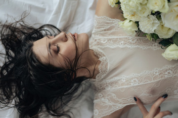 Girl with white roses and amaryllis on a white background