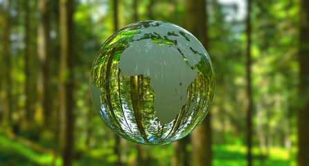 3D illustration - Planet Earth shaped like a crystal ball in a green forest - 329205160