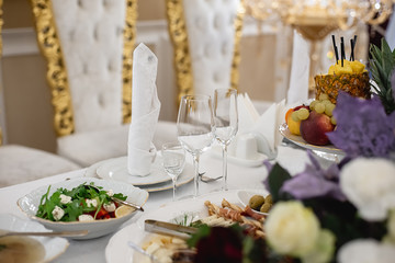 Elegant dinner table setting in restaurant or hotel with wine glasses. Luxurious elegant dinner at the table. Holiday table decoration