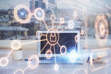 Computer on desktop with social network hologram. Multi exposure. Concept of international people connections.