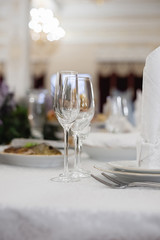 Wine glasses and glasses on the server table.Luxurious elegant dinner at the table in the restaurant. Holiday table decoration
