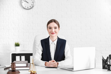 Female lawyer sitting at workplace in office