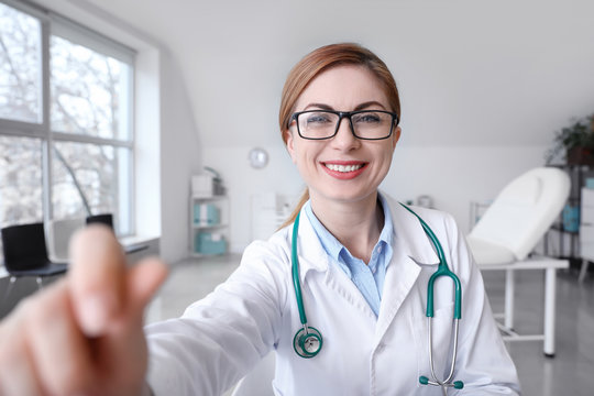 Female Doctor Using Video Chat In Clinic