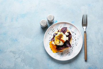 Tasty egg Benedict on color background