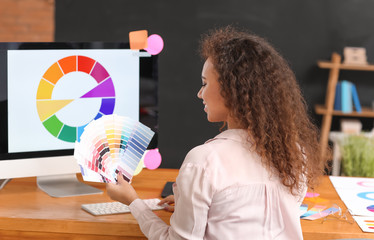 African-American designer with color palettes in office